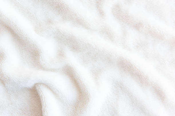 Soft, white fleece blanket showing its fluffy texture.